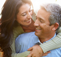 A loving middle-aged couple holding on to each other.  Psychic Love Reading